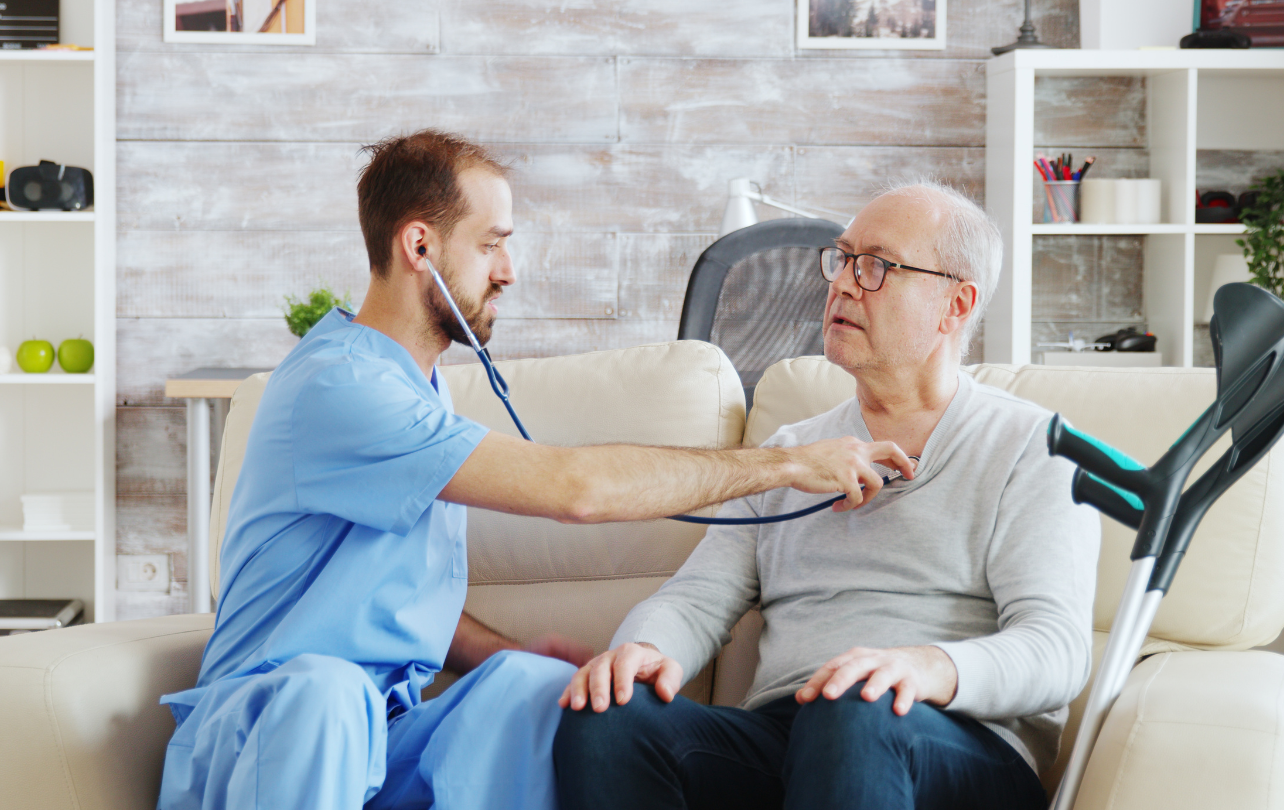 Home healthcare nurse caring for elderly patient at home